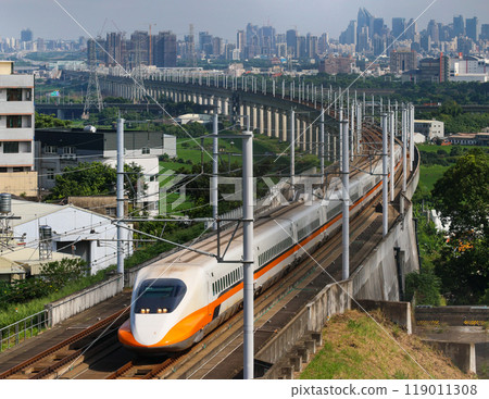 Taiwan's high speed train curves with the cityscape in the background 119011308