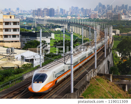 Taiwan's high speed train curves with the cityscape in the background Taiwan's high speed train curves with the cityscape in the background 119011309
