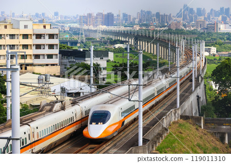 Taiwan's high speed train curves with the cityscape in the background Taiwan's high speed train curves with the cityscape in the background 119011310