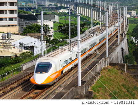 Taiwan's high speed train curves with the cityscape in the background Taiwan's high speed train curves with the cityscape in the background 119011311
