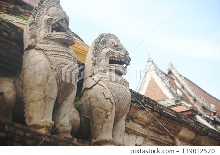 Beautiful and complete lion statue at the base of the main pagoda of Wat Mae Nang Pluem. which is another ancient temple in Phra Nakhon Si Ayutthaya Historical Park in Thailand. 119012520