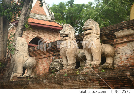 Beautiful and complete lion statue at the base of the main pagoda of Wat Mae Nang Pluem. which is another ancient temple in Phra Nakhon Si Ayutthaya Historical Park in Thailand. 119012522