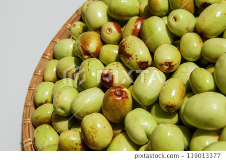 Jujube fruits in a colander (gray background) Jujube fruits in a colander (gray background) 119013377
