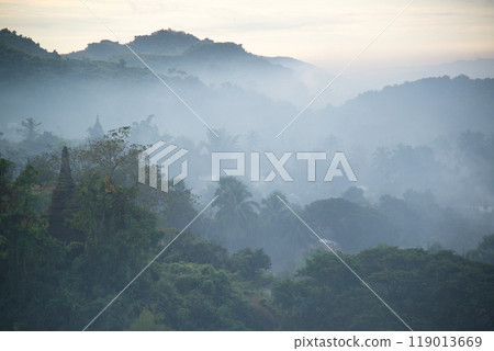 Early morning on the mountain top beautiful sunrise and gentle light In the valley there is fog that stretches like a wet sea. Fog - to good weather at Mrauk-U , Rakhine State, Myanmar. 119013669