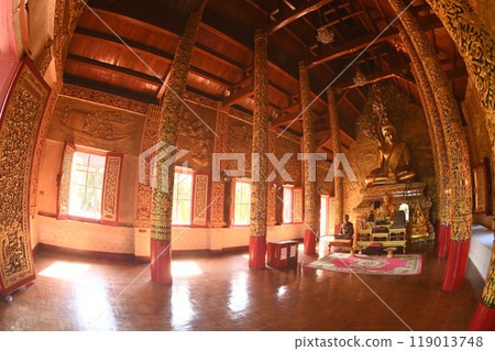 A large Buddha image sits in a golden color. Inside Buddhist Church at Wat Phra Phutthabat Tak Pha temple. This temple is an important place of worship in Lamphun Province , Northern of Thailand. A large Buddha image sits in a golden color. Inside Buddhist Church at Wat Phra Phutthabat Tak Pha temple. This temple is an important place of worship in Lamphun Province , Northern of Thailand. 119013748