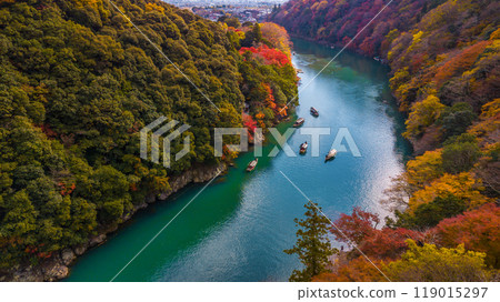 Arashiyama in autumn season along the river in Kyoto, Japan, Aerial view Arashiyama Togetsu or Togetsukyo bridge ancient architecture and boats in Katsura river, Arashiyama, Kyoto, Japan, Asia. Arashiyama in autumn season along the river in Kyoto, Japan, Aerial view Arashiyama Togetsu or Togetsukyo bridge ancient architecture and boats in Katsura river, Arashiyama, Kyoto, Japan, Asia. 119015297