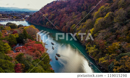 Arashiyama in autumn season along the river in Kyoto, Japan, Aerial view Arashiyama Togetsu or Togetsukyo bridge ancient architecture and boats in Katsura river, Arashiyama, Kyoto, Japan, Asia. Arashiyama in autumn season along the river in Kyoto, Japan, Aerial view Arashiyama Togetsu or Togetsukyo bridge ancient architecture and boats in Katsura river, Arashiyama, Kyoto, Japan, Asia. 119015298