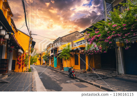 Streets with traditional ancient yellow houses in old town in Hoi An city in Vietnam in summer at sunset 119016115