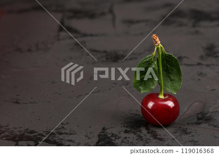 Fresh red cherries with green leaves isolated on black background. Natural background. Fresh red cherries with green leaves isolated on black background. Natural background. 119016368