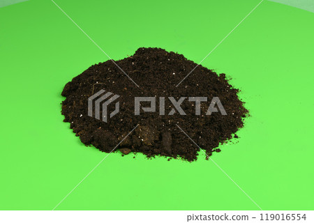 Heap of soil isolated on green background. Heap of soil isolated on green background. 119016554