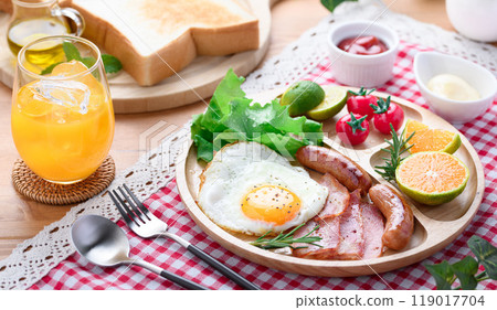 Breakfast image (bread, fried egg, sausage, bacon, mandarin oranges, orange juice) 119017704