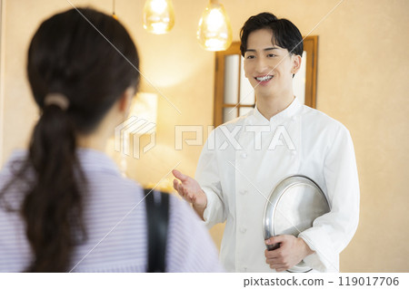 A young man wearing a chef's coat A young man wearing a chef's coat 119017706