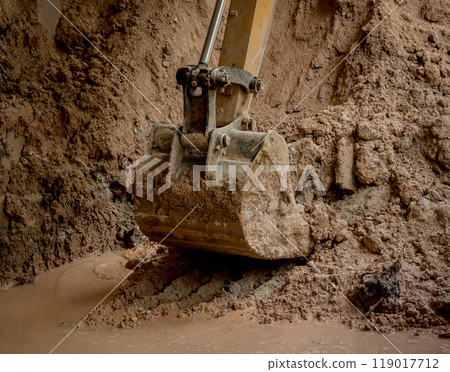 A significant pile of ground is being excavated by a bulldozer 119017712