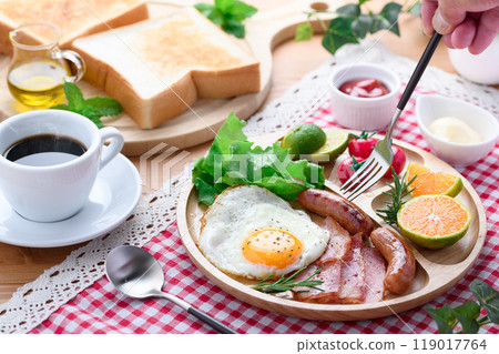 Breakfast image (bread, salad, fried egg, sausage, bacon, coffee) 119017764