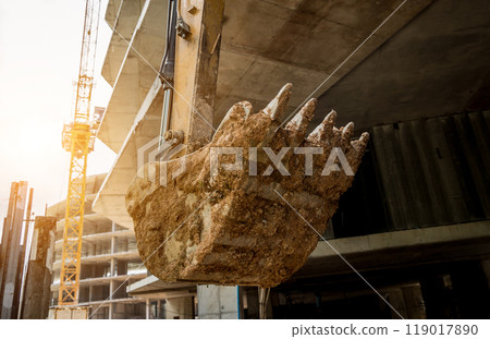 A significant pile of ground is being excavated by a bulldozer A significant pile of ground is being excavated by a bulldozer 119017890