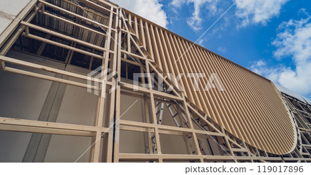 A structure featuring wooden slats on construction site contributing to its architectural style 119017896