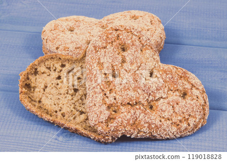 Fresh homemade wholegrain bread in shape of heart for breakfast Fresh homemade wholegrain bread in shape of heart for breakfast 119018828