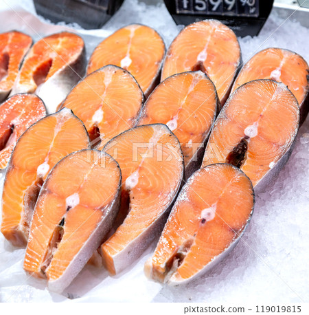 Sliced steaks of fresh salmon fish on the counter 119019815