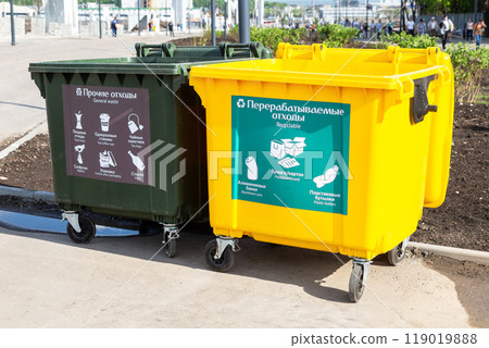 Separate trash containers on city street. Text in russian 119019888