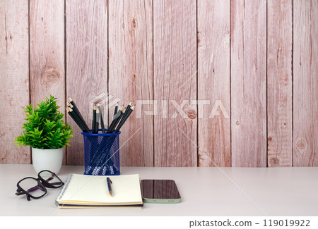Workspace mock up white table top with vintage notebook, Pencils and green houseplant. Copy space desk with copy space for products display montage. Minimalist white workplace with supplies. Workspace mock up white table top with vintage notebook, Pencils and green houseplant. Copy space desk with copy space for products display montage. Minimalist white workplace with supplies. 119019922