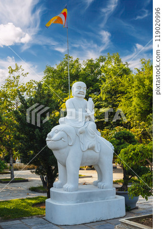 white Buddhist statue of Buddha sitting on an animal in park at the Linh Ung Pagoda in Da Nang in Vietnam in summer in Asia white Buddhist statue of Buddha sitting on an animal in park at the Linh Ung Pagoda in Da Nang in Vietnam in summer in Asia 119020996