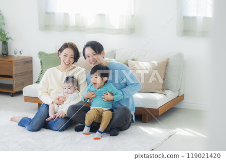 A family relaxing in the living room A family relaxing in the living room 119021420