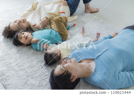 A family relaxing in the living room A family relaxing in the living room 119021444