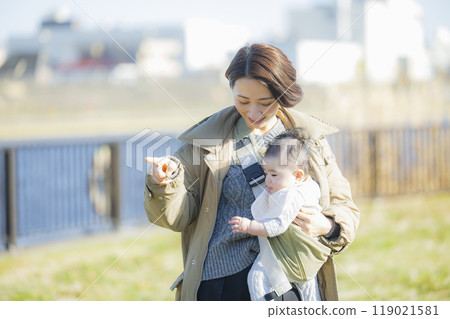 A mother holding her baby on a winter walk A mother holding her baby on a winter walk 119021581