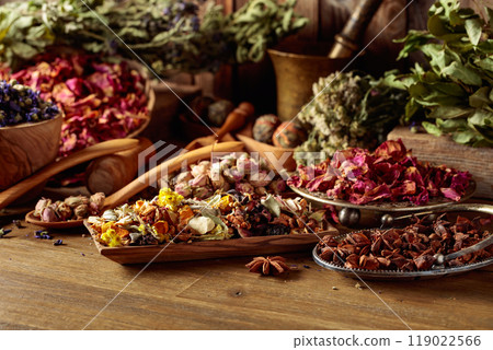 Various dried medicinal plants, herbs, and flowers on an old wooden background. Various dried medicinal plants, herbs, and flowers on an old wooden background. 119022566