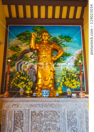 golden statue inside the interior of Buddhist temple in Asia in Vietnam 119023034