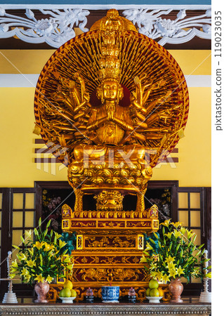Golden statue of Buddhist deity inside the interior of temple in Asia in Vietnam 119023035