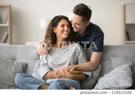 Cheerful attractive couple in love enjoying leisure at home 119023380