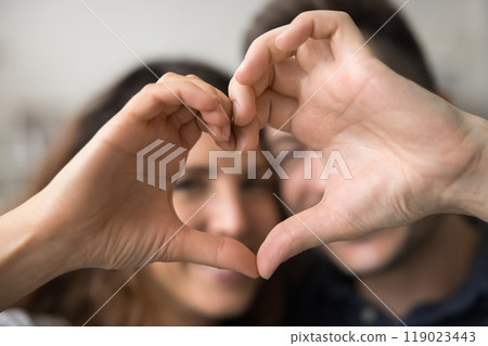 Hand heart shape with happy faces of young couple 119023443