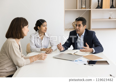 Diverse business team partners discuss agreement details in office 119023482