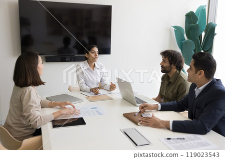 Inspired Indian female business trainer talk to interested multiethnic trainees Inspired Indian female business trainer talk to interested multiethnic trainees 119023543