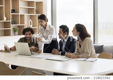 Young Indian woman coach explain project details to diverse interns Young Indian woman coach explain project details to diverse interns 119023562