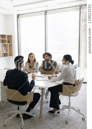 Diverse stakeholders team hold briefing discuss idea by conference table 119023592
