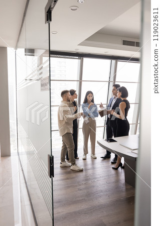 Multiethnic team of serious managers discussing teamwork in modern office 119023611