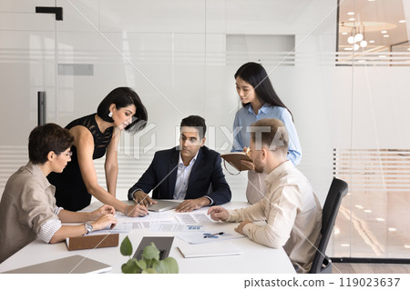 Diverse business group of colleagues discussing paper reports 119023637