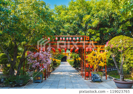 gate decorated with Chinese lanterns to park with trees in a garden on Buddhist pagoda in Asia 119023765