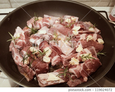mixed pork meat cooked in a pan with rosemary and sage, butter, oil and salt 119024072