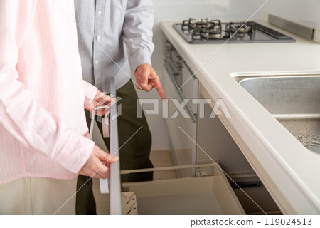 A middle-aged to senior couple looking at a rental apartment 119024513