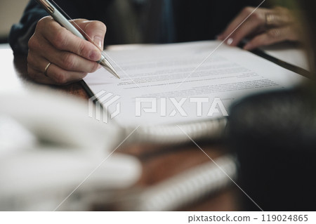 Low angle view of businesswoman proofreading a document 119024865