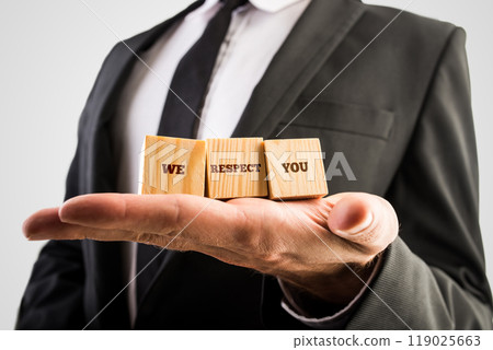Businessman holding three wooden cubes with the words - We respect you 119025663