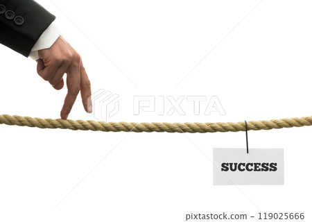 Businessman walking his fingers along a length of rope or a tightrope towards success Businessman walking his fingers along a length of rope or a tightrope towards success 119025666