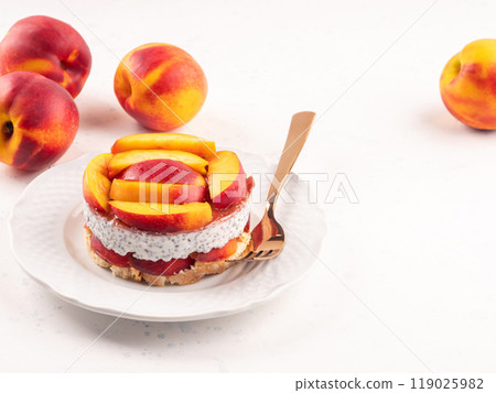 Overnight chia pudding dessert with greek yogurt, peaches and jam 119025982