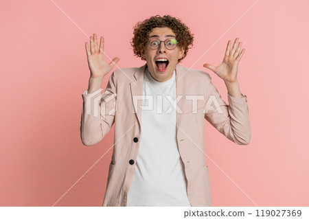 Excited amazed man surprise looking at camera with big eyes shocked by sudden victory wow emotion 119027369