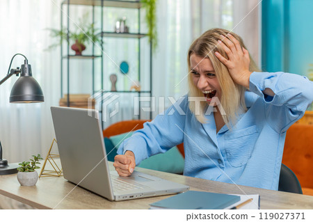 Displeased businesswoman using laptop surprised bad news fortune loss game fail computer virus error Displeased businesswoman using laptop surprised bad news fortune loss game fail computer virus error 119027371