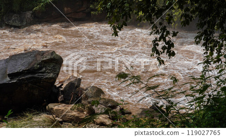 A strong current near a waterfall. Floods flowing in mountain rivers after heavy rains. Flash floods, the effects of global warming and the effects of deforestation. 119027765