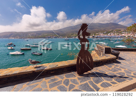 View of Cadaques with mountains in the background on a sunny day. View of Cadaques with mountains in the background on a sunny day. 119028292